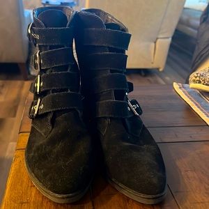 Black suede low heeled booties with buckles and side zip from Dolce Vita